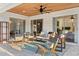 Relaxing covered patio features wood ceiling, fan, and comfortable seating overlooking the backyard at 652 Rochester St, Oviedo, FL 32765