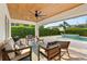 Relaxing covered patio features wood ceiling, fan, and comfortable seating with a pool at 652 Rochester St, Oviedo, FL 32765