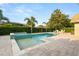 Backyard pool and spa surrounded by lush landscaping and a brick-paved patio at 652 Rochester St, Oviedo, FL 32765