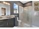Sleek bathroom with a granite vanity, glass-enclosed shower, and modern fixtures at 748 Desert Mountain Ct, Reunion, FL 34747