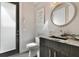 Stylish powder room with a unique vanity, decorative mirror, and modern fixtures at 748 Desert Mountain Ct, Reunion, FL 34747