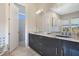 Bathroom featuring double vanity with granite countertops and soaking tub at 748 Desert Mountain Ct, Reunion, FL 34747