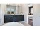 Modern bathroom with double vanity, granite countertops, ample cabinet space, and a soaking tub at 748 Desert Mountain Ct, Reunion, FL 34747