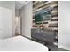 Bedroom boasts a wood accent wall and is equipped with a dresser and TV at 748 Desert Mountain Ct, Reunion, FL 34747