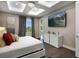 Modern bedroom with a large bed, decorative lighting, and sliding glass door to a balcony at 748 Desert Mountain Ct, Reunion, FL 34747
