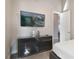 Modern bedroom with a TV, sleek dresser, and access to an en-suite bathroom at 748 Desert Mountain Ct, Reunion, FL 34747