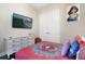 Bright bedroom featuring a white dresser, TV and large double door closet at 748 Desert Mountain Ct, Reunion, FL 34747