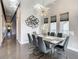 Elegant dining area features natural light and a long wooden table with seating for eight at 748 Desert Mountain Ct, Reunion, FL 34747