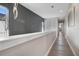 Bright hallway with modern lighting, neutral walls, and wood flooring at 748 Desert Mountain Ct, Reunion, FL 34747