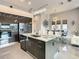 Gourmet kitchen features stainless steel appliances, marble countertop, and a chandelier in an open-concept layout at 748 Desert Mountain Ct, Reunion, FL 34747