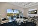 Spacious living room features a large glass window, a leather couch, and modern decor at 748 Desert Mountain Ct, Reunion, FL 34747