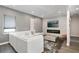 Modern living room with a white couch, modern fireplace, and light neutral decor at 748 Desert Mountain Ct, Reunion, FL 34747