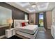 Bright bedroom with tray ceiling, stylish decor, and sliding door to outdoor space at 748 Desert Mountain Ct, Reunion, FL 34747