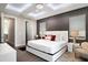 Well-lit bedroom with decorative lighting, neutral walls, a white bed frame, and a walk-in closet at 748 Desert Mountain Ct, Reunion, FL 34747