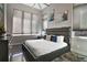 Cozy bedroom featuring a large bed with stylish headboard, plenty of natural light, and neutral decor at 748 Desert Mountain Ct, Reunion, FL 34747