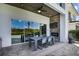 Stylish outdoor living space featuring a fireplace, tv, and an outdoor dining set at 748 Desert Mountain Ct, Reunion, FL 34747