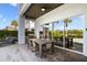 Covered patio with outdoor dining and seating area, complete with barbecue grill and view of the pool at 748 Desert Mountain Ct, Reunion, FL 34747
