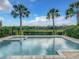 Inviting backyard pool featuring tranquil views, perfect for relaxation and outdoor enjoyment with palm trees and beautiful skies at 748 Desert Mountain Ct, Reunion, FL 34747
