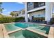 Beautiful pool and spa with outdoor seating and modern house exterior at 748 Desert Mountain Ct, Reunion, FL 34747