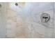 Modern shower featuring large marble-look tiles, a rainfall showerhead, and sleek fixtures at 748 Desert Mountain Ct, Reunion, FL 34747