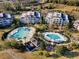 Aerial view of the community with multiple pools and various amenities at 7652 Whisper Way # 301, Reunion, FL 34747