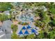 Aerial view of a water park featuring a splash pad, slides, and shaded seating at 7652 Whisper Way # 301, Reunion, FL 34747
