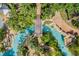 Aerial view of a lazy river with clear water, lush landscaping and a bridge at 7652 Whisper Way # 301, Reunion, FL 34747