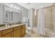 Well-lit bathroom with a vanity, a granite countertop, and a shower-tub combination at 7652 Whisper Way # 301, Reunion, FL 34747