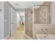 Bathroom showing a glass enclosed shower with a view into an adjacent bedroom at 7652 Whisper Way # 301, Reunion, FL 34747
