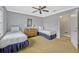 Cozy bedroom featuring twin beds, a ceiling fan, and neutral decor, creating a relaxing space at 7652 Whisper Way # 301, Reunion, FL 34747