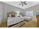 Bright bedroom with a ceiling fan, two twin beds, and a side table with a lamp at 7652 Whisper Way # 301, Reunion, FL 34747