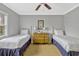 Charming bedroom featuring twin beds and a center dresser at 7652 Whisper Way # 301, Reunion, FL 34747