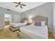 Bright bedroom with two beds, a ceiling fan, and doorway to the bathroom at 7652 Whisper Way # 301, Reunion, FL 34747