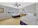 Bright bedroom with two beds, a dresser, and a window providing natural light at 7652 Whisper Way # 301, Reunion, FL 34747