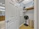 Organized closet with shelves, hanging space, and a fan for ventilation, located near the bathroom at 7652 Whisper Way # 301, Reunion, FL 34747