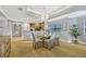 Dining area with a glass table, upholstered chairs, and kitchen view at 7652 Whisper Way # 301, Reunion, FL 34747