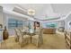 Bright dining area with glass table, wicker furniture, and view of living space at 7652 Whisper Way # 301, Reunion, FL 34747