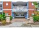 Covered entrance with brick accents, elegant columns, and address displayed at 7652 Whisper Way # 301, Reunion, FL 34747