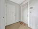 Entryway with two white doors, a welcome mat, and neutral walls at 7652 Whisper Way # 301, Reunion, FL 34747