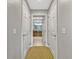 Hallway with dual doors leading to bathroom featuring a large vanity with a granite countertop at 7652 Whisper Way # 301, Reunion, FL 34747