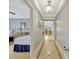 Hallway leading to a bedroom, showcasing tile flooring and neutral wall colors at 7652 Whisper Way # 301, Reunion, FL 34747