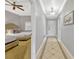 Hallway featuring tiled flooring, crown molding, and view into the main bedroom at 7652 Whisper Way # 301, Reunion, FL 34747