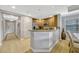Galley kitchen with stainless steel appliances, wood cabinetry, and breakfast bar at 7652 Whisper Way # 301, Reunion, FL 34747