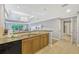 Bright kitchen featuring granite countertops and stainless steel sink, opening to the living area at 7652 Whisper Way # 301, Reunion, FL 34747