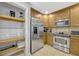 Updated kitchen with stainless steel appliances, wood cabinets, and walk in pantry at 7652 Whisper Way # 301, Reunion, FL 34747