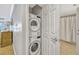 Laundry closet with a stacked washer and dryer located next to the bathroom at 7652 Whisper Way # 301, Reunion, FL 34747