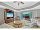 Comfortable living room with TV, ceiling fan, and sliding doors to a balcony at 7652 Whisper Way # 301, Reunion, FL 34747