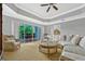 Bright living room with wicker furniture, tray ceiling, and sliding doors to a balcony at 7652 Whisper Way # 301, Reunion, FL 34747