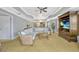 Bright living room with wicker furniture, ceiling fan, and open floor plan to the kitchen at 7652 Whisper Way # 301, Reunion, FL 34747