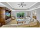 Living room featuring wicker furniture, entertainment center, and access to a balcony at 7652 Whisper Way # 301, Reunion, FL 34747